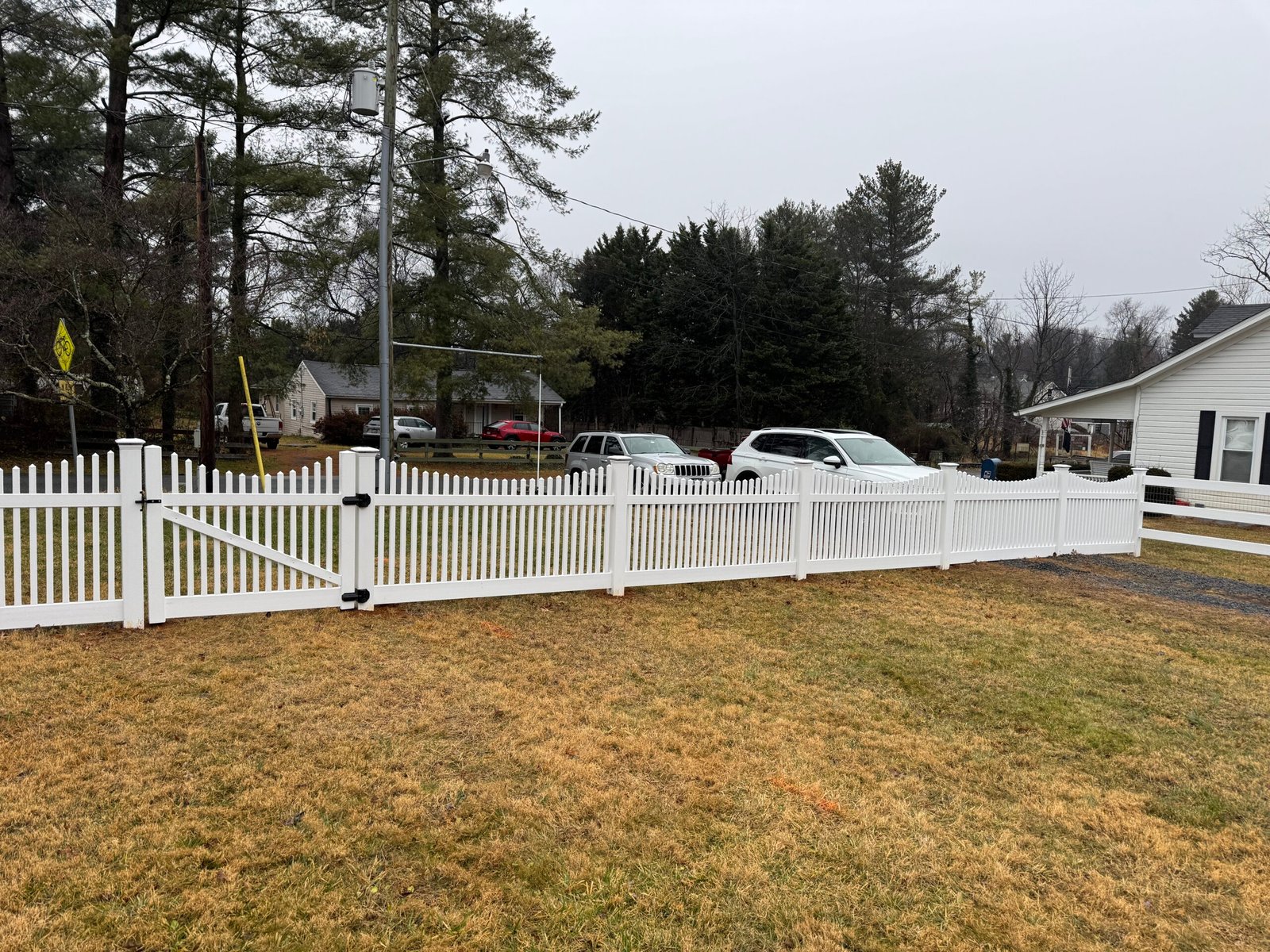 White fence and gate installation at a residence