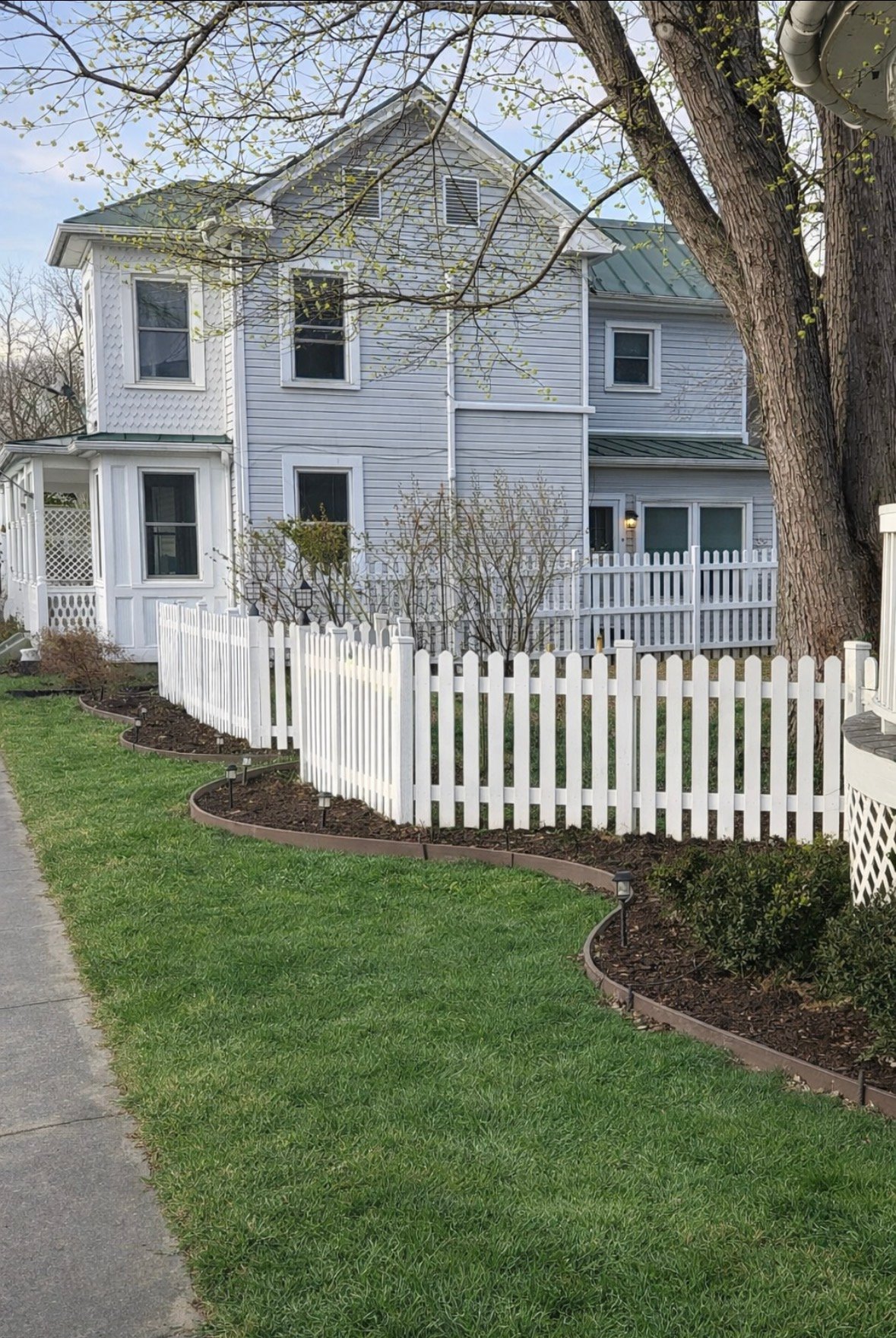 White picket fence in a front yard
